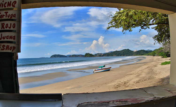 Playa Flamingo beach with a fishing boat at low tide